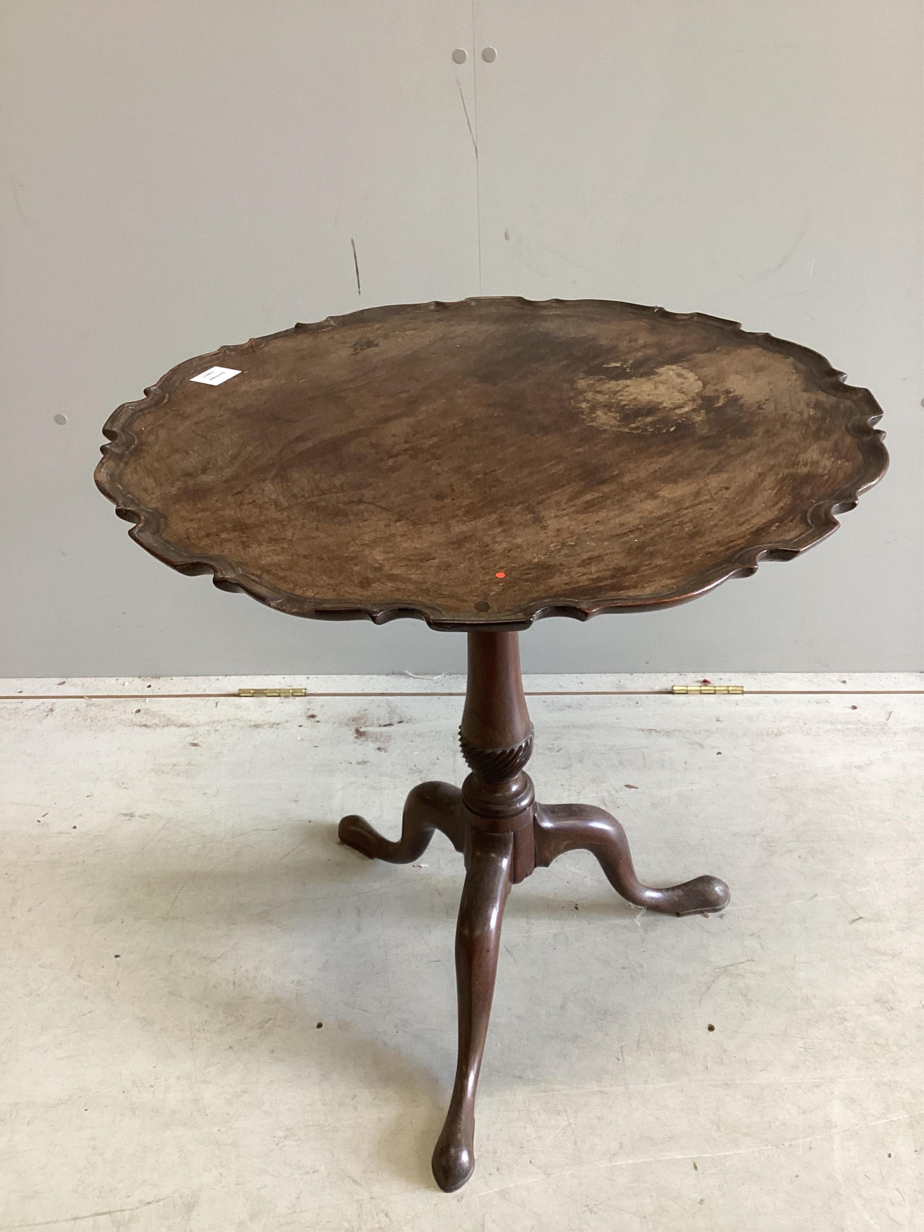 A George III circular mahogany piecrust tilt top tripod tea table, diameter 66cm, height 69cm. Condition - poor